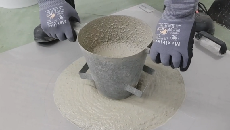 Messung des Ausfließmaß für Vergussbetone mittels eines Setztrichters.